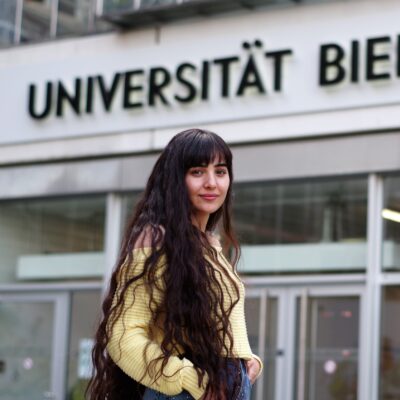 Photo of Ahin Hassaf by the main entrance of Bielefeld University.
