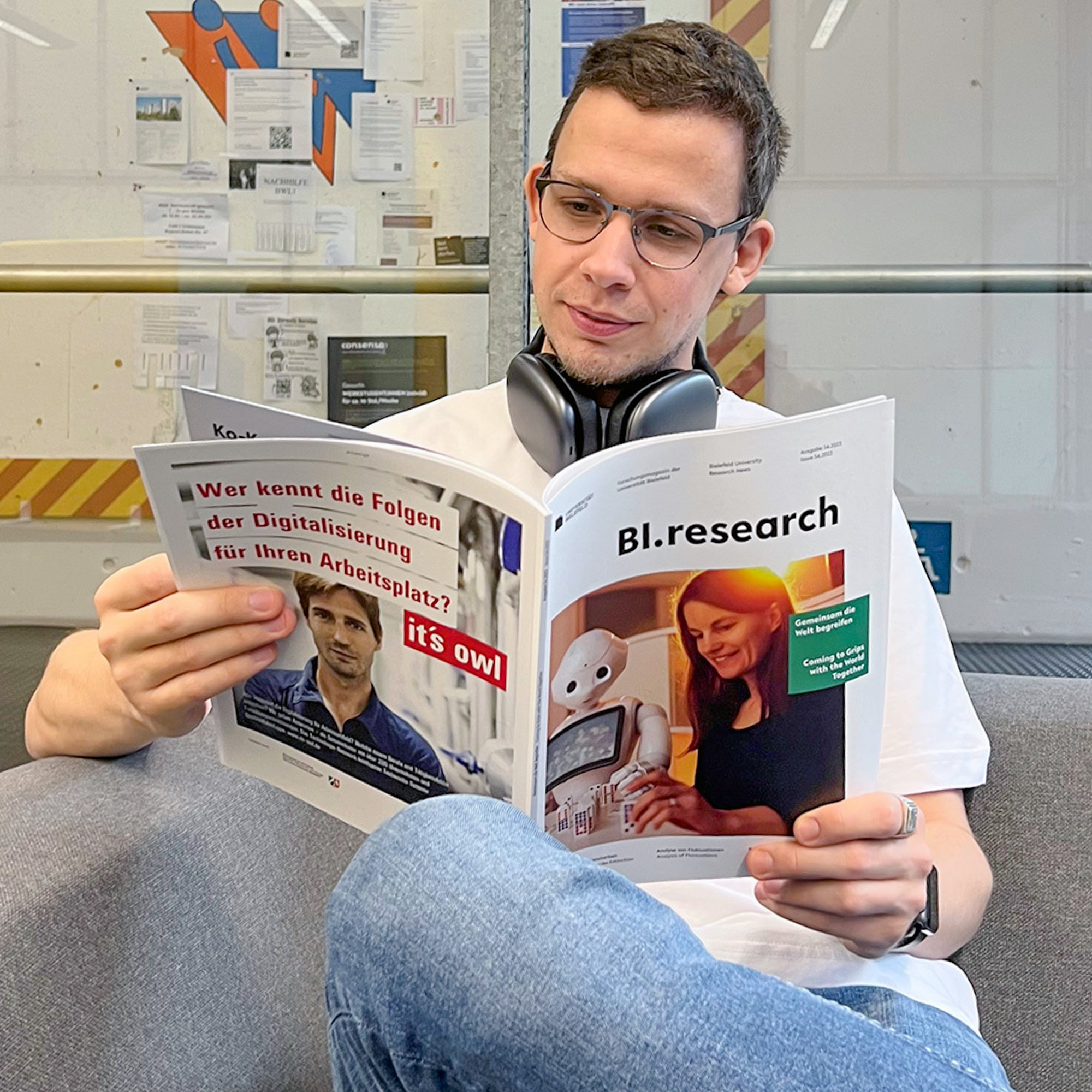 Image of a man reading the research magazine 