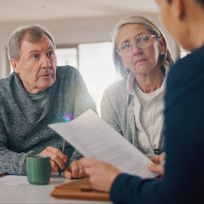 Conversation, documents and senior couple with financial advisor for retirement annuity saving account. Meeting, finance paperwork and elderly man and woman with investment banker for pension growth.