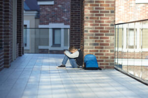 schoolboy crying in the hallway of the school