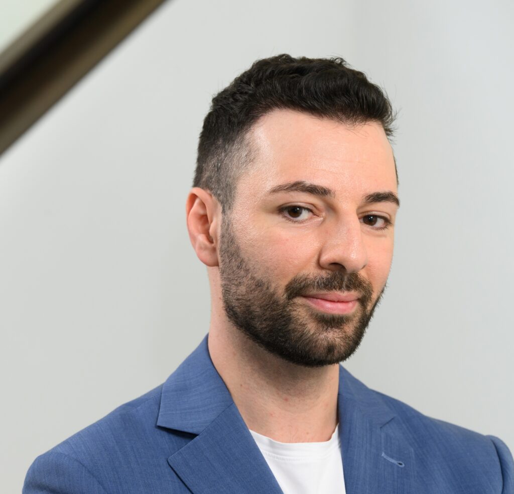 Portrait of Dr Usama EL-Awad wearing a blue jacket